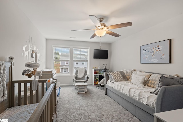 carpeted living room featuring ceiling fan