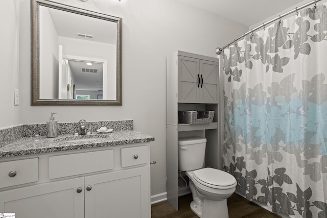 bathroom featuring vanity, toilet, curtained shower, and wood-type flooring