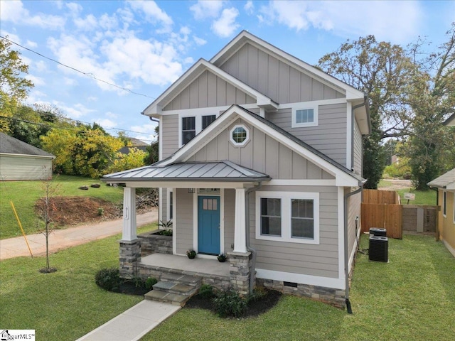 view of front of house featuring cooling unit, a front yard, and a porch