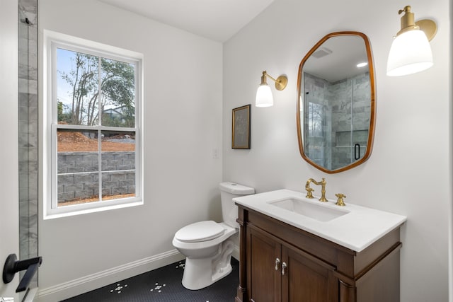 bathroom featuring vanity, toilet, and a shower with shower door