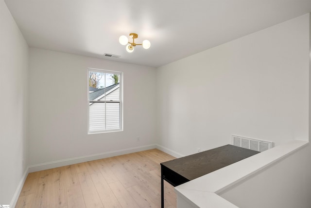 interior space featuring an inviting chandelier and light hardwood / wood-style floors