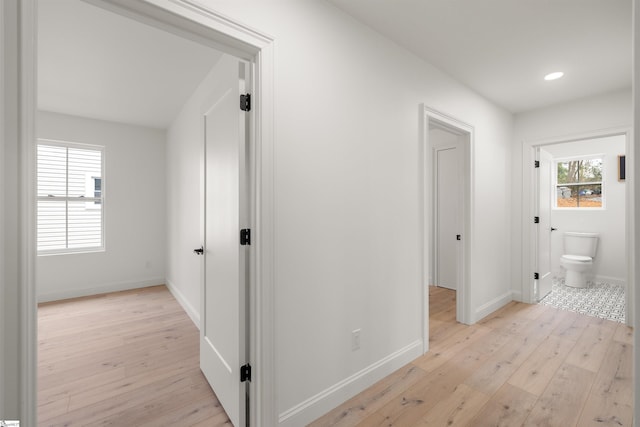 hallway with light hardwood / wood-style flooring