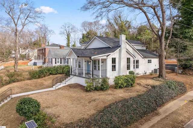 exterior space with central AC unit and a front lawn