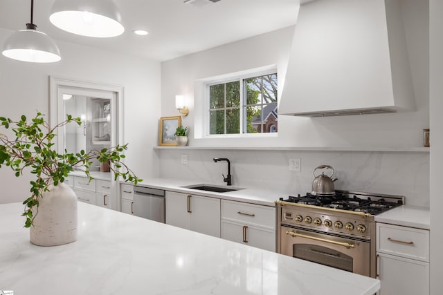 kitchen with sink, white cabinets, hanging light fixtures, stainless steel appliances, and light stone countertops