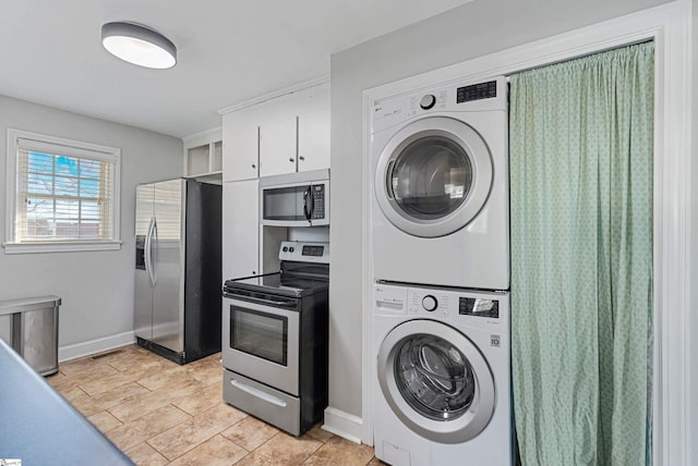 laundry area with stacked washer and dryer