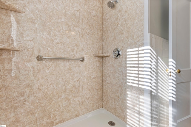 bathroom with tiled shower