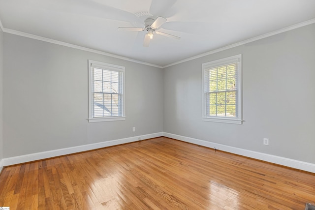 unfurnished room with ornamental molding, a wealth of natural light, and light hardwood / wood-style floors