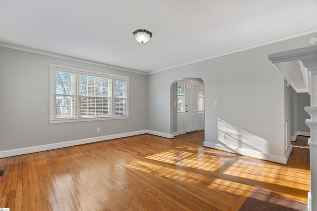 empty room with crown molding and hardwood / wood-style floors