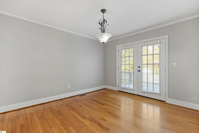 unfurnished room with french doors, crown molding, and light hardwood / wood-style flooring