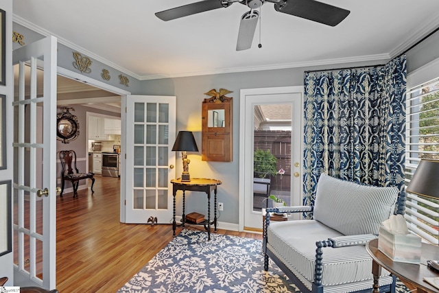 sitting room featuring crown molding, ceiling fan, light hardwood / wood-style floors, and french doors