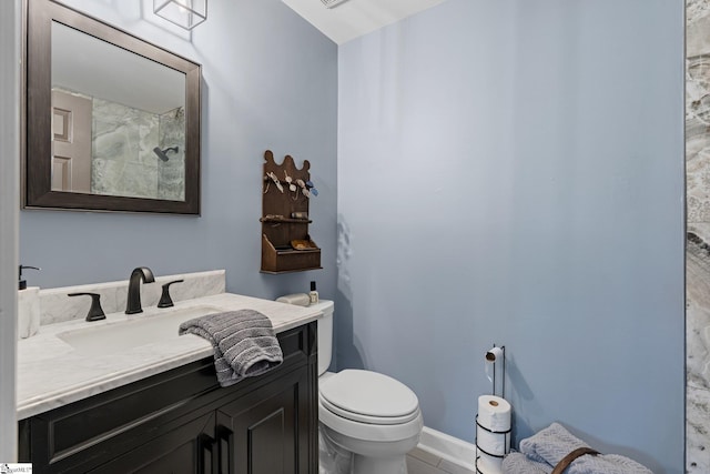 bathroom featuring tile patterned floors, vanity, and toilet