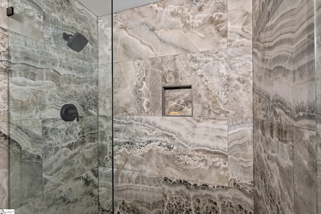 interior details featuring a tile shower