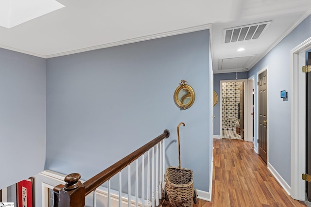 hallway featuring hardwood / wood-style flooring and ornamental molding