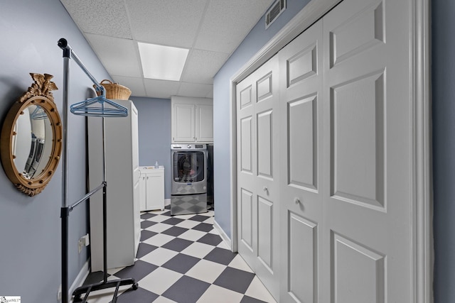 laundry area with cabinets and washer / clothes dryer