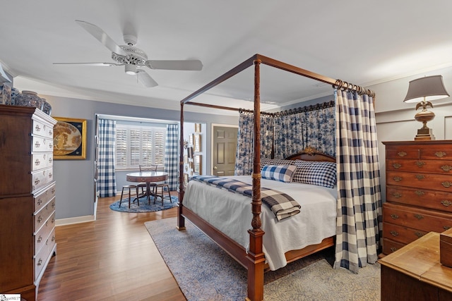 bedroom with ceiling fan, ornamental molding, and hardwood / wood-style floors