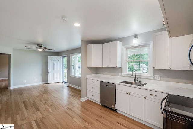 kitchen with a wealth of natural light, stainless steel dishwasher, light wood-style floors, white cabinetry, and a sink