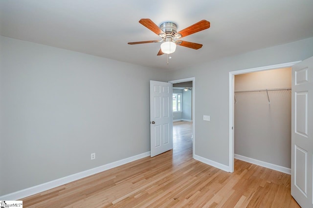 unfurnished bedroom with a closet, light wood-type flooring, a ceiling fan, and baseboards