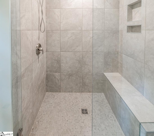 bathroom with tiled shower