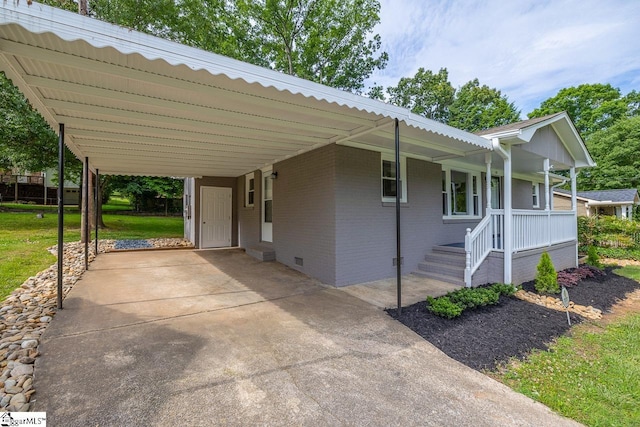 view of front facade with concrete driveway, brick siding, crawl space, and an attached carport