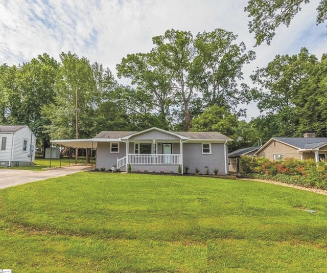 ranch-style home with a porch, a carport, and a front lawn