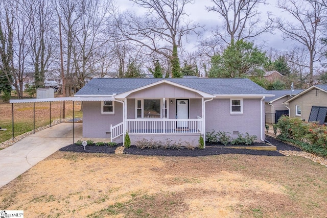 view of front of home featuring brick siding, crawl space, a porch, and a shingled roof