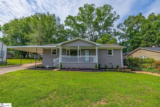 ranch-style home featuring an attached carport, covered porch, a front lawn, and concrete driveway