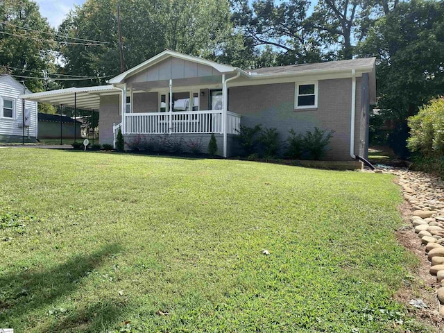 ranch-style house with a carport, a porch, a front yard, and brick siding