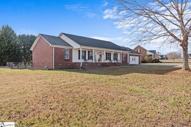 single story home featuring a porch, a garage, and a front yard