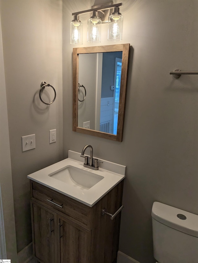 half bathroom featuring toilet and vanity