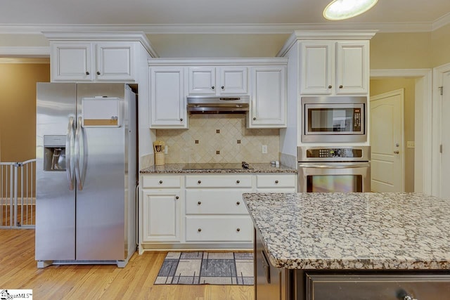 kitchen featuring stainless steel appliances, ornamental molding, white cabinets, and light hardwood / wood-style flooring