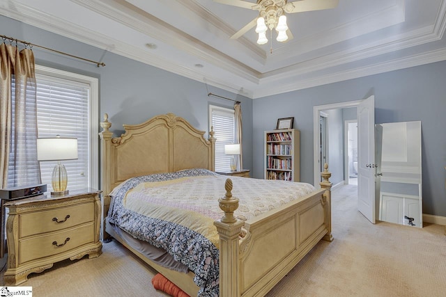 bedroom with light carpet, a tray ceiling, ornamental molding, and ceiling fan