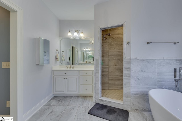 bathroom featuring vanity, tile walls, and separate shower and tub