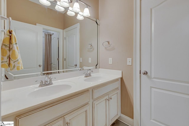 bathroom with vanity and a notable chandelier