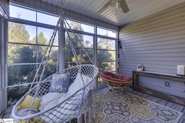 sunroom featuring ceiling fan