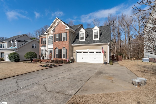 view of property with a garage and a front lawn