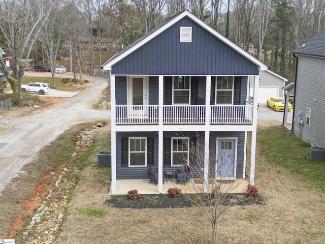 exterior space featuring a garage, central AC, and covered porch