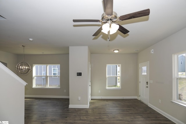 unfurnished living room featuring dark hardwood / wood-style floors and a chandelier