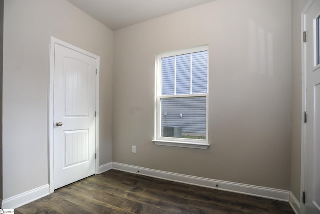 spare room featuring dark wood-type flooring