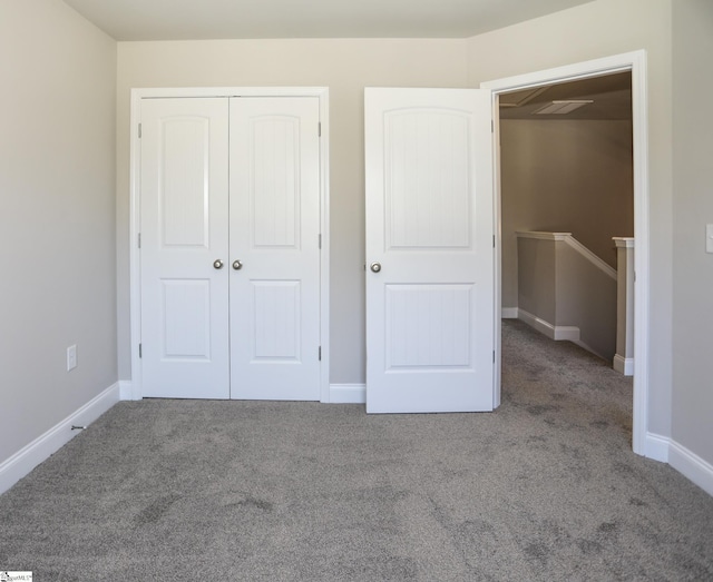 unfurnished bedroom with carpet flooring and a closet