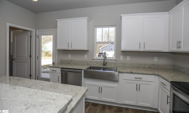 kitchen featuring stainless steel appliances, white cabinetry, sink, and light stone counters