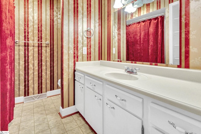 bathroom featuring vanity and toilet