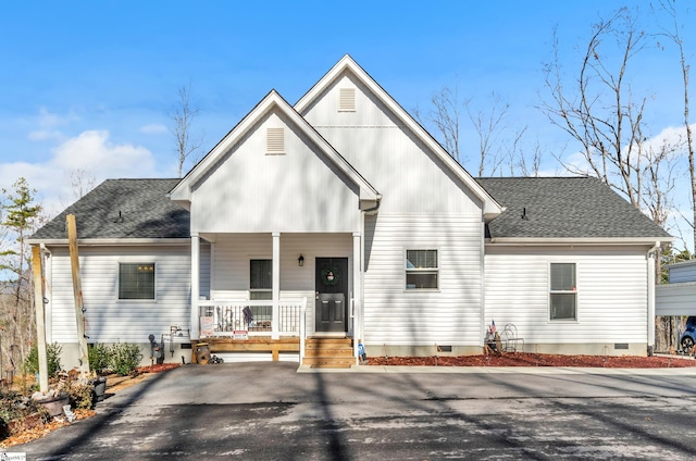 view of front facade featuring a porch, crawl space, roof with shingles, and aphalt driveway