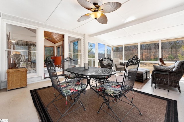 sunroom featuring vaulted ceiling with beams and ceiling fan