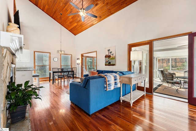 living room featuring hardwood / wood-style flooring, ceiling fan, high vaulted ceiling, and wooden ceiling