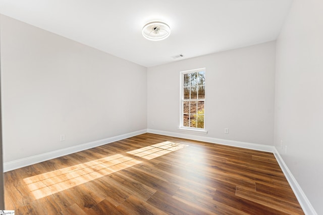 unfurnished room with hardwood / wood-style flooring