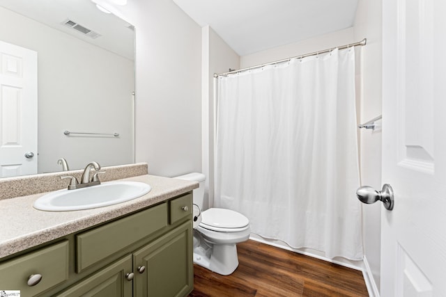 bathroom featuring vanity, hardwood / wood-style floors, and toilet