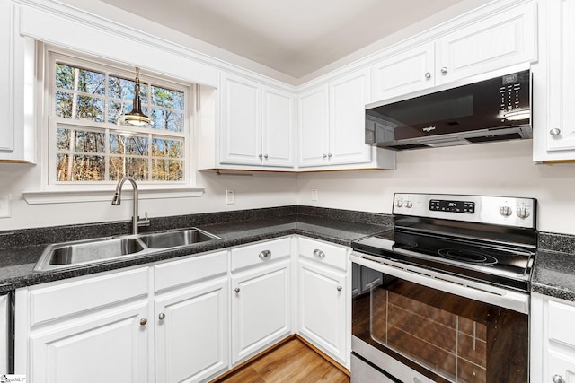 kitchen featuring sink, stainless steel electric range, and white cabinets