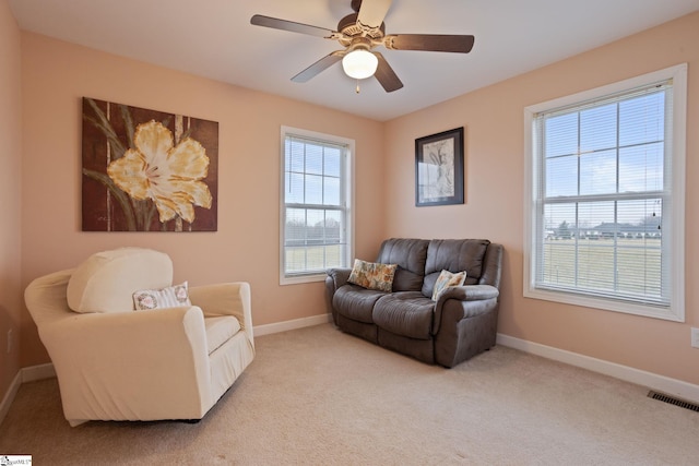 living room featuring ceiling fan and light carpet