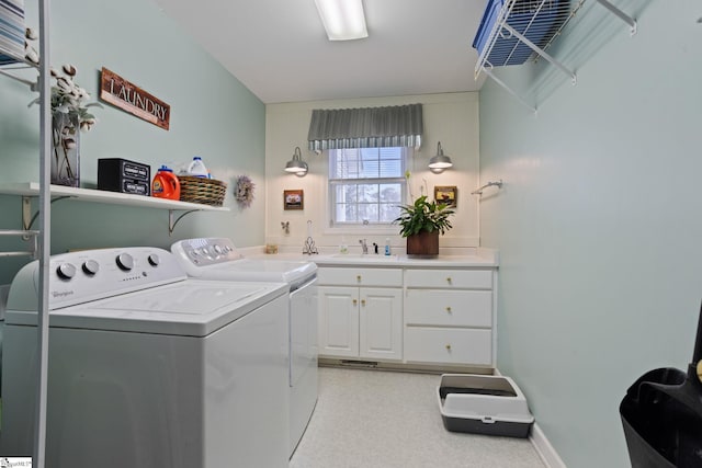 washroom featuring sink, cabinets, and washer and dryer