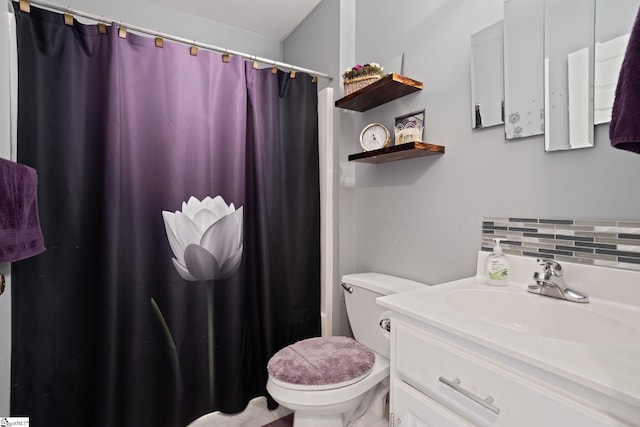 bathroom with tasteful backsplash, vanity, and toilet